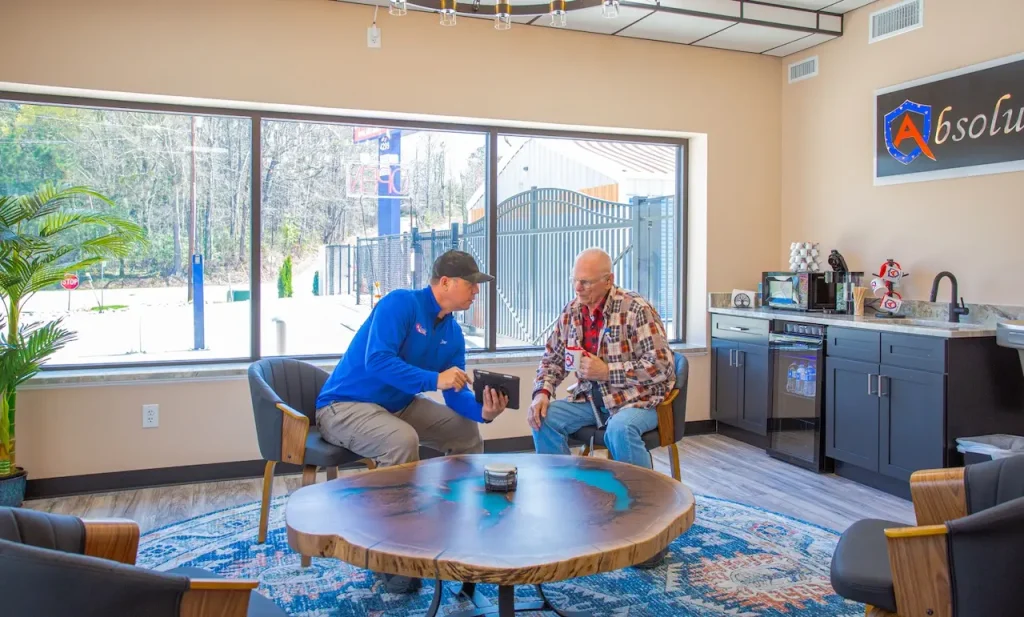 Two men discussing tablet in modern office lobby