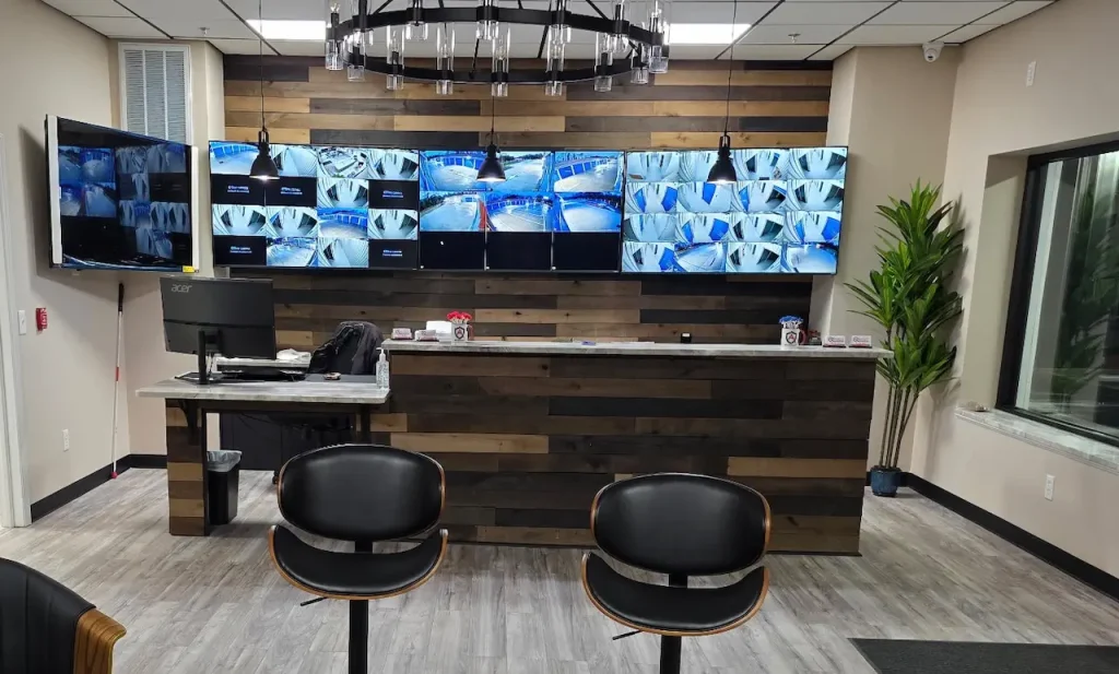 Modern security office with surveillance monitors and desk